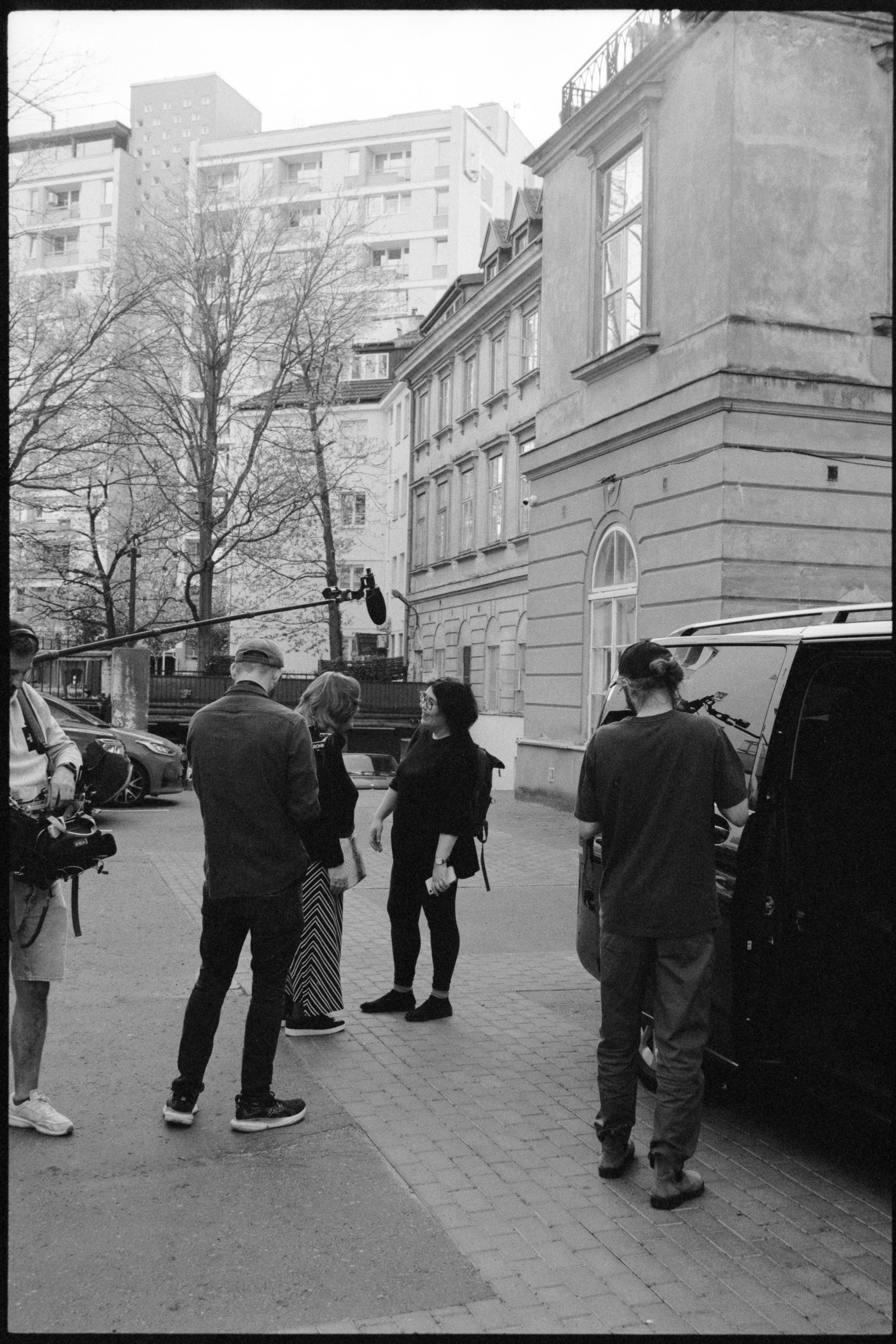 The crew at work in the street: boom operator, camera, and the production van.